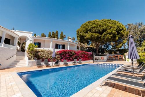 a villa with a swimming pool and a house at Lagos Appartement Resort in Lagos