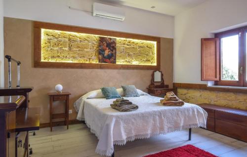 a bedroom with a bed with towels on it at Pet Friendly Home In Palermo With Kitchen in Palermo