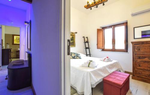 a room with a bed with a table and a window at Pet Friendly Home In Palermo With Kitchen in Palermo
