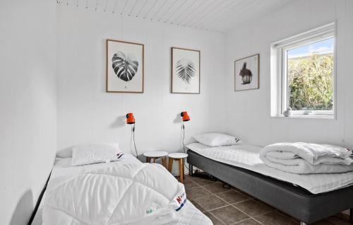 a bedroom with two beds and a window at Amazing Home In Grsten With House Sea View in Gråsten