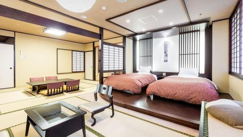 Postel nebo postele na pokoji v ubytování U-BELL Hotel Matsumasa