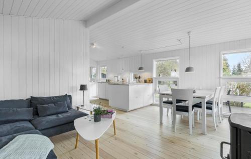 a living room and kitchen with a couch and a table at 3 Bedroom Cozy Home In Gilleleje in Gilleleje