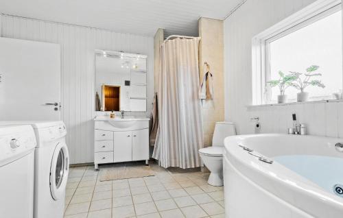 La salle de bains blanche est pourvue d'une baignoire, de toilettes et d'un lavabo. dans l'établissement Stunning Home In Sydals With Kitchen, à Skovbyballe