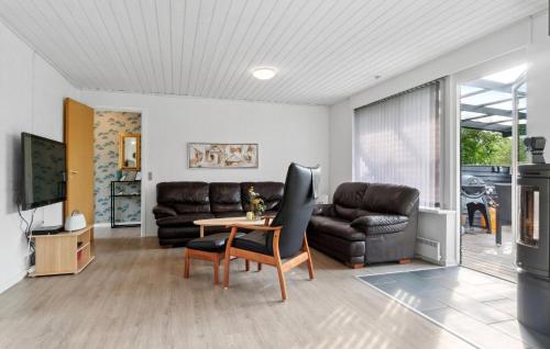 a living room with a couch and a table at 2 Bedroom Stunning Home In Vinderup in Vinderup