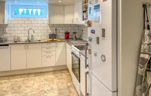 a kitchen with a white refrigerator and a sink at 2 Bedroom Amazing Apartment In Vimmerby in Vimmerby