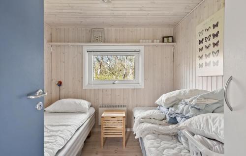 a bedroom with two beds and a window at Stunning Home In Dronningmlle With Wifi in Dronningmølle