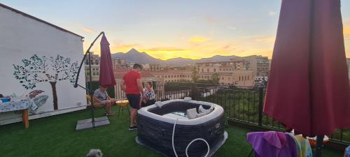 a man standing on a balcony with a hot tub at I Sollazzi in Palermo
