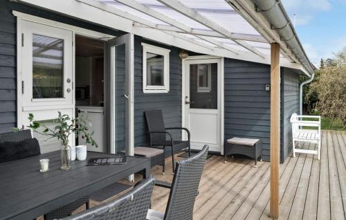 a patio with a table and chairs on a deck at Three-Bedroom Holiday Home In Gedser in Gedser