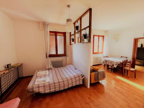 a bedroom with a bed and a dining room at Casa Elena in Arezzo