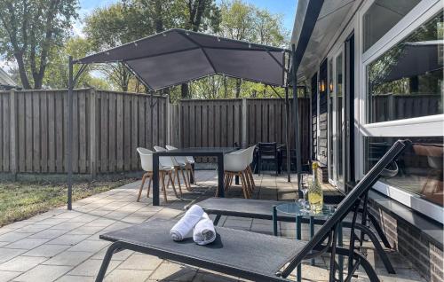 a patio with a table and chairs and an umbrella at Lovely Home In Meijel With Wifi in Meijel