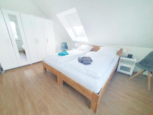 a bedroom with a bed with a bag on it at Ferienwohnung Beste - für eine entspannte Auszeit in Bad Oldesloe