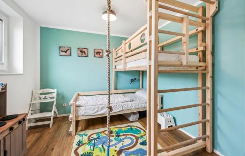 a room with two bunk beds and a swing at Lovely Home In Lembruchdümmer See in Lembruch