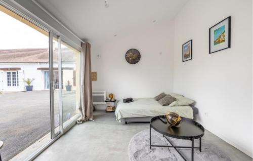 a white bedroom with a bed and a table at Lovely Apartment In Amblainville in Amblainville