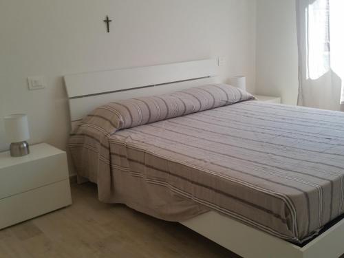 um quarto com uma cama grande e uma grande cabeceira. em Nettuno Apartament em Tirrenia