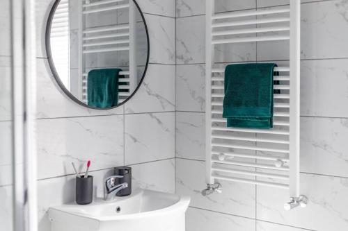 a white bathroom with a mirror and a sink at 4 Bed House Contractor & Leisure in Preston