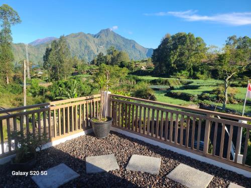 a balcony with a view of the mountains at Batur lake view in Kintamani