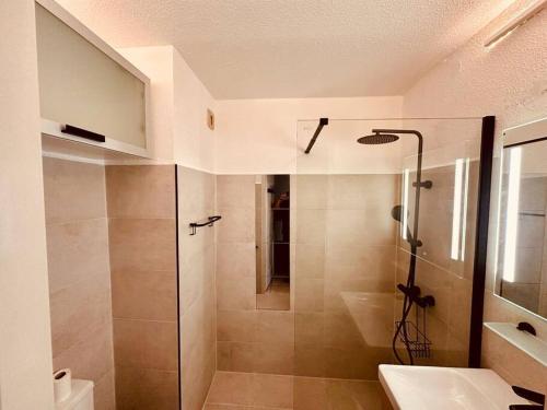 une salle de bain avec douche et lavabo dans l'établissement Charmant T2 rénové avec vue mer, à Cervione