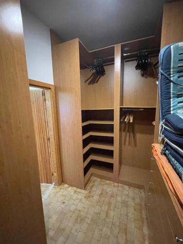 a room with a walk in closet with blue clothes at Villa Vista Pannonia in Donnerskirchen