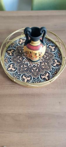 a tea pot on a glass plate on a table at Caryatids Luxury Apartment in Athens