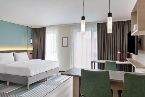 a hotel room with a bed and a desk at Residence Inn by Marriott Hamburg Altona in Hamburg