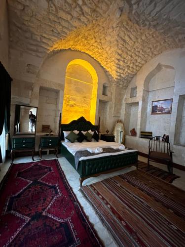 a bedroom with a bed in a large room at Nomad inn in Urfa