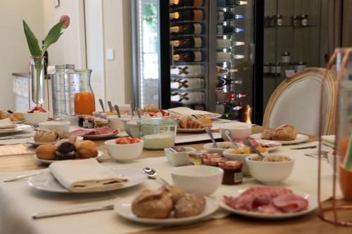 a table with plates of food on top of it at Villa Nonna Cicci Boutique Hotel - SPA in Cisterna dʼAsti