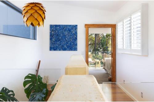 a dining room with a table and a window at Always Summer Boomerang in Boomerang Beach