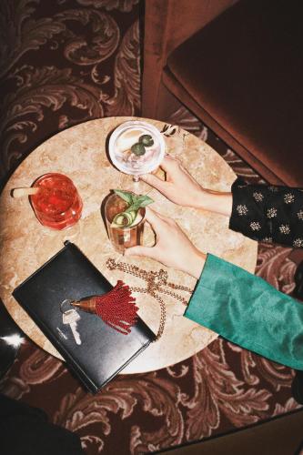 a woman with her hands on a table with a plate at Hotel Bella Grande in Copenhagen