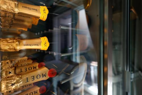 a bunch of wine bottles in a display case at Villa Nonna Cicci Boutique Hotel - SPA in Cisterna dʼAsti