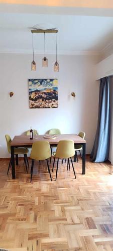 a dining room with a table and chairs at Caryatids Luxury Apartment in Athens