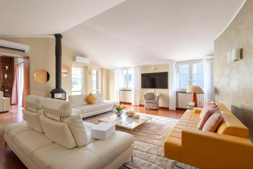 a living room with a couch and a table at Heart Milan Apartments San Sepolcro Duomo in Milan
