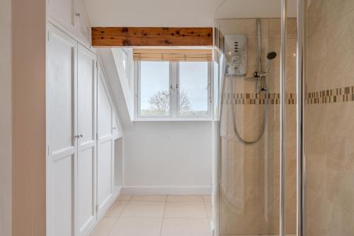 a bathroom with a shower and a window at Esk Valley House in Sleights