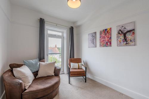 a living room with a couch and a window at Esk Valley House in Sleights