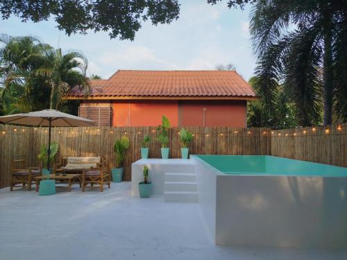 a backyard with a swimming pool and a fence at Luana Villas in Ko Lanta