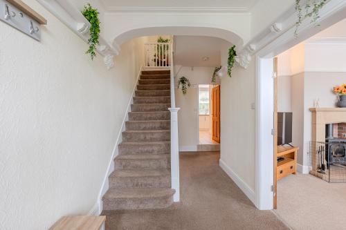 a staircase in a home with white walls at Esk Valley House in Sleights