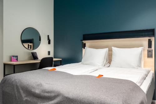 a bedroom with a large bed and a mirror at Citybox Tallinn City Center in Tallinn