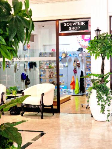 a furniture store with a white chair and a sign at Sveltos Hotel in Larnaca
