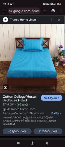 a page of a bedroom with a bed with blue sheets at SHRII SAI LIKITHA BOY'S HOSTEL in Hyderabad