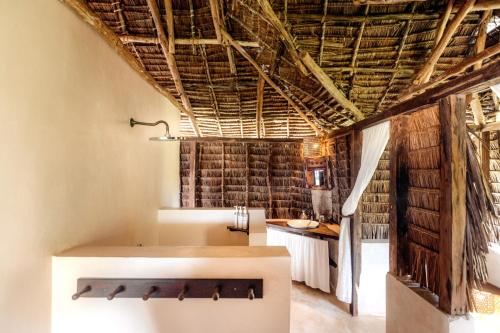 a bathroom with a bath tub in a room at The Cabanas Lamu in Lamu