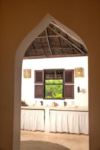 a bathroom with a sink and a window at The Cabanas Lamu in Lamu