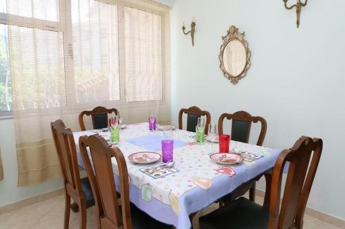 a dining room table with a blue table cloth on it at Toni Apartment Berat in Berat