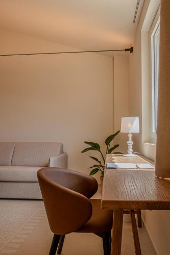 a living room with a table and a chair at Moliké country house in Giulianova