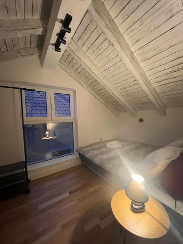 a bedroom with a bed and a table with a lamp at Garni Hotel TIANIS in Kotor