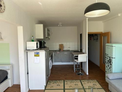 a kitchen with a refrigerator and a table in a room at Ruhige sonnige 1,5 Zimmer Wohnung in Erfurt