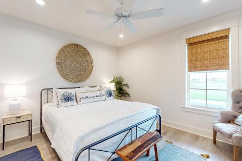 a bedroom with a bed and a ceiling fan at Fairway Sunsets in Port Aransas
