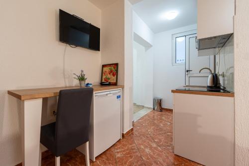 a kitchen with a counter and a desk in a room at Villa Jadranka Sutomore in Sutomore