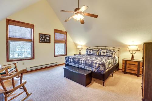 a bedroom with a bed and a ceiling fan at Serene Poconos Cabin with Hot Tub and Beach Access! in Albrightsville
