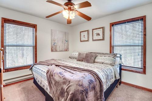 a bedroom with a bed and a ceiling fan at Serene Poconos Cabin with Hot Tub and Beach Access! in Albrightsville