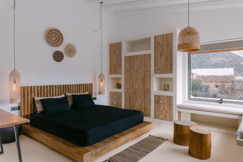 a bedroom with a bed and a window at Villa Aldea - Luxury Boho Style in Melidhónion