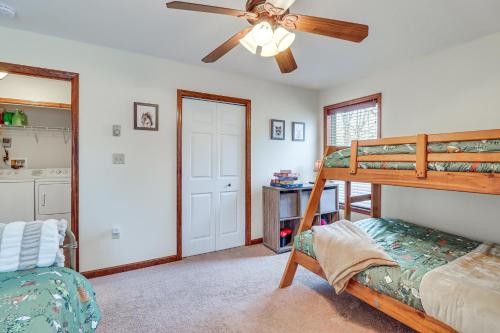 a bedroom with a bunk bed and a ceiling fan at Serene Poconos Cabin with Hot Tub and Beach Access! in Albrightsville
